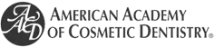 The image shows a logo with text that reads  AMERICAN ACADEMY OF COSMETIC DENTISTRY  in capital letters, flanked by two circular emblems on either side of the text.