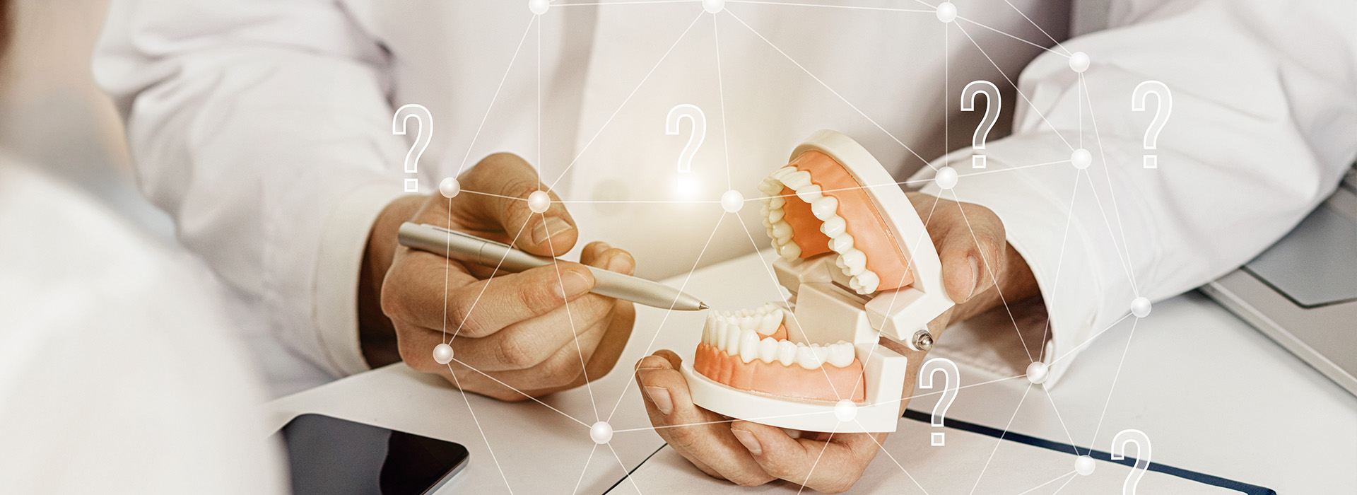 The image shows a person s hands holding a dental implant with a question mark overlaying the scene, suggesting an interactive element where a user can select from multiple options displayed at the bottom of the image.