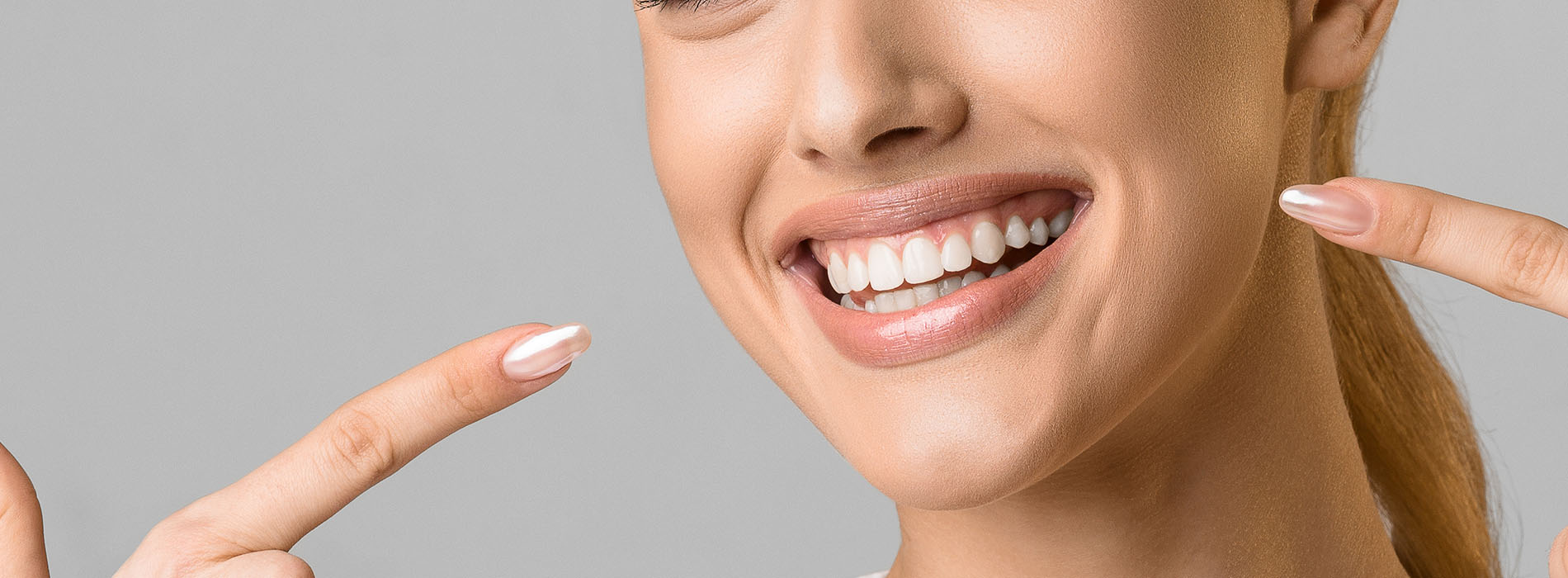 The image shows a close-up of a person s face with a smile, displaying a dental product advertisement.