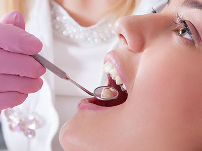 A person receiving dental care with a focus on the dental professional s workstation.